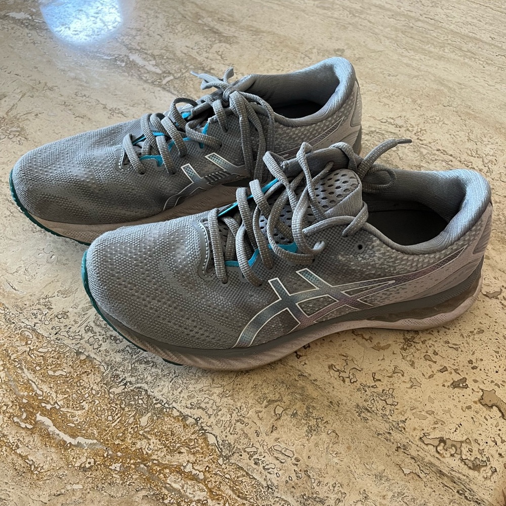 ASIC brand tennis shoes. Like new condition, gray with blue trim. Size 8 1/2
